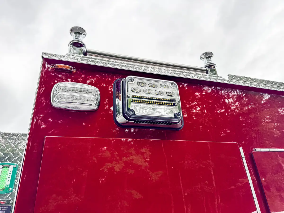 Rear scene light close-up from angled view with mounting base and body seam.